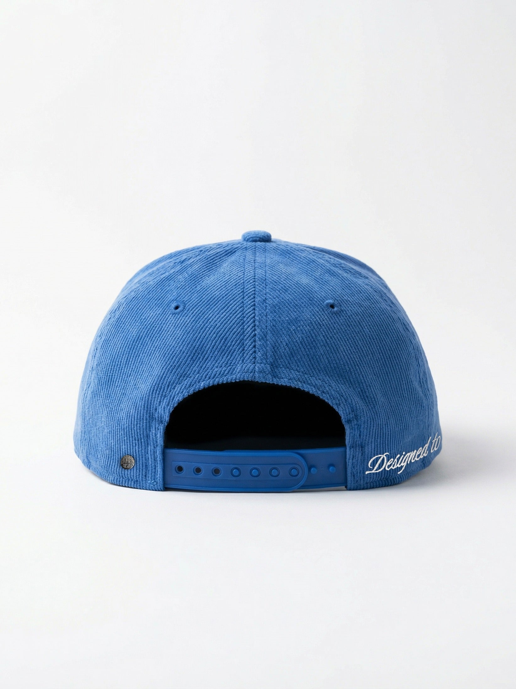Vue arrière de la casquette Morex Custom en velours côtelé bleu avec fermeture snapback ajustable et broderie blanche.