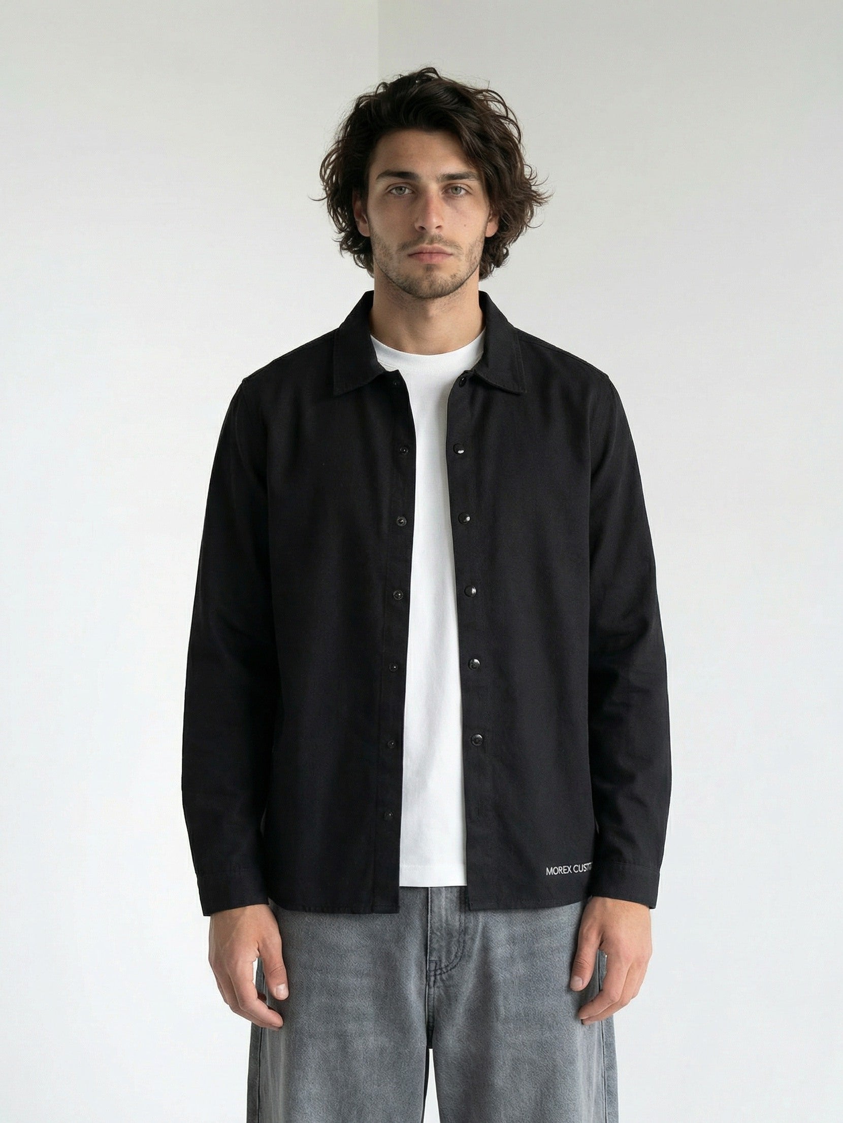 Homme portant une chemise noire Morex Custom à manches longues sur un t-shirt blanc, style lifestyle urbain et décontracté.