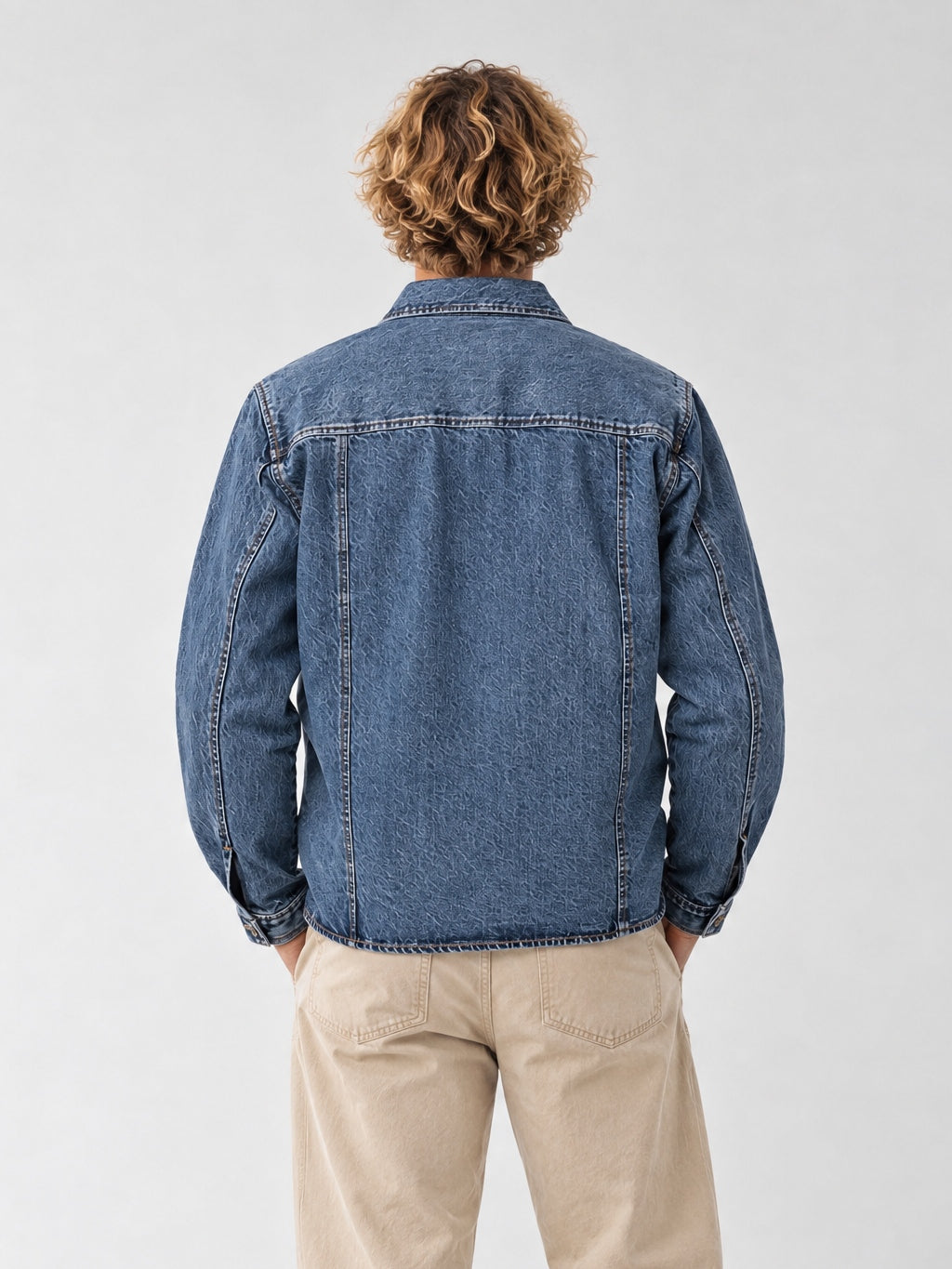 Vue arrière de la veste en jean bleu délavé Morex Custom, coupe droite vintage portée avec un pantalon beige pour un look moto lifestyle.